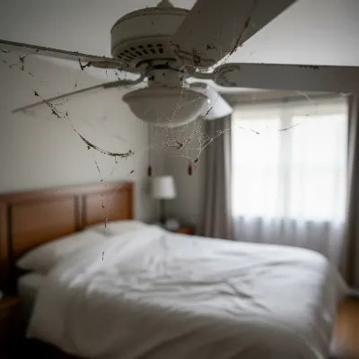 Dusty bedroom ceiling fan blades showing visible accumulation of dirt and grime, highlighting the need for cleaning