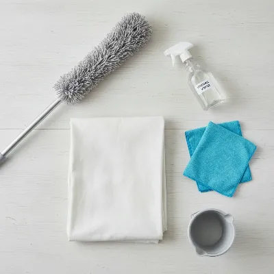 Various cleaning tools for a mess-free ceiling fan cleaning process arranged neatly